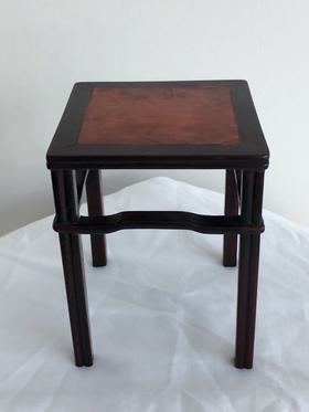 A square hardwood inlay burl wood stand