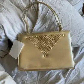 Mini gold bejeweled handle bag
