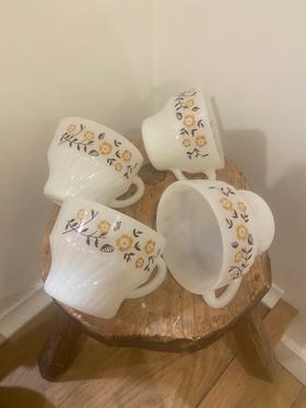 Set of four milk glass mugs