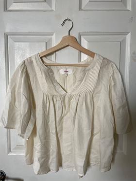Loose, cream-colored short sleeve blouse